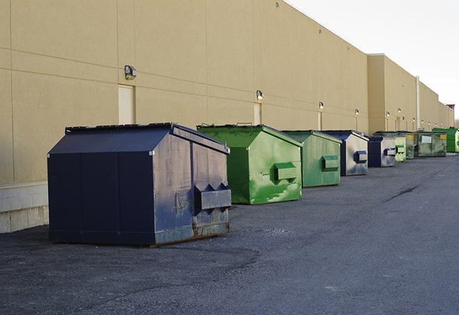 construction workers carrying construction debris to a dumpster in Delray Beach, FL